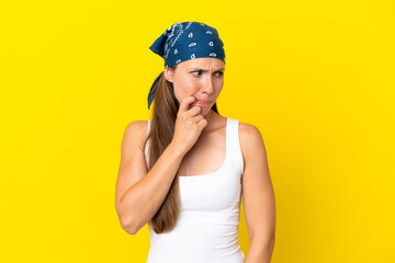 Young English woman isolated on yellow background nervous and scared