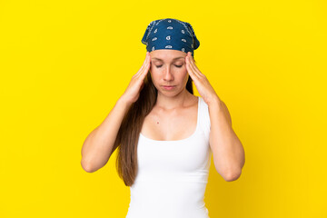 Young English woman isolated on yellow background with headache