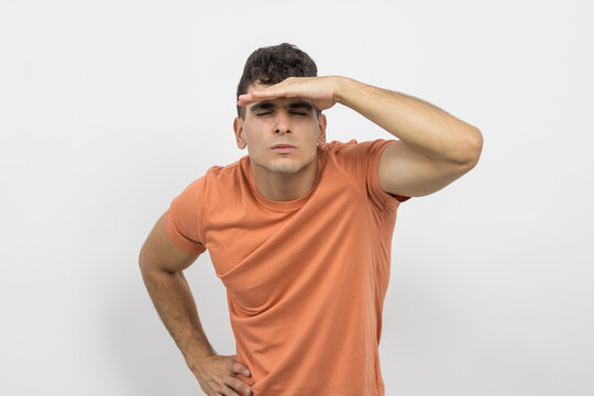 a young boy straining his eyes because he has myopia on a white background.