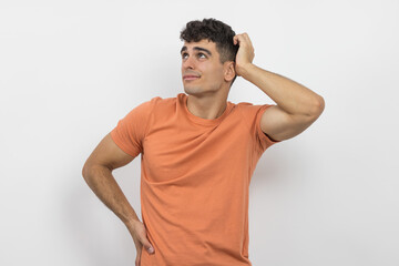 a young boy touching his head while thinking.