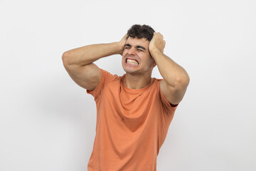 
a young boy holding his hair because he is angry on a white background.