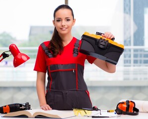 Young woman in coveralls doing repairs