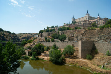 Fototapeta na wymiar The imposing El Alcazar fortress at Toledo, Spain. Historic medieval monument dominating the beautiful old Spanish city. Landscape aspect view with copy space.