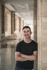 Obraz premium Portrait of asian young handsome man in casual clothing standing outdoors and smiling. Chinese people, real life, looking at camera with copy space