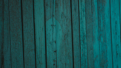 Background of green flaky wood. Backdrop of green colored wooden panels with aged flaky surface