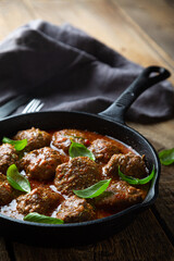 Homemade meatballs in tomato sauce with fresh basil
