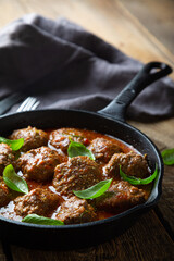 Homemade meatballs in tomato sauce with fresh basil