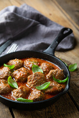 Homemade meatballs in tomato sauce with fresh basil