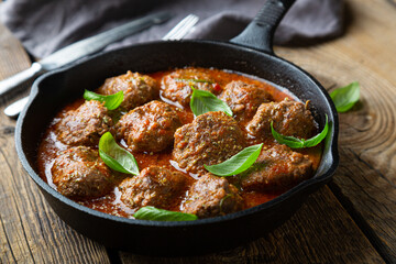 Homemade meatballs in tomato sauce with fresh basil