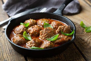 Homemade meatballs in tomato sauce with fresh basil