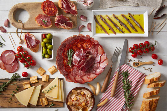 A Wooden Table With Typical Spanish Food Seen From Above