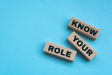 Above are three wooden blocks with the words KNOW YOUR ROLE.