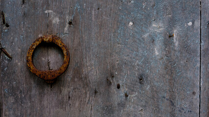 antique iron door knocker on old wooden door