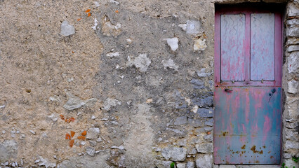 ancient pink and blue door with old wall. House entrance
