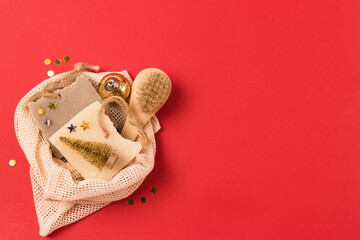 Holiday Christmas Gift Natural Soaps Bamboo Face Brush Golden Confetti Red Background Copy Space