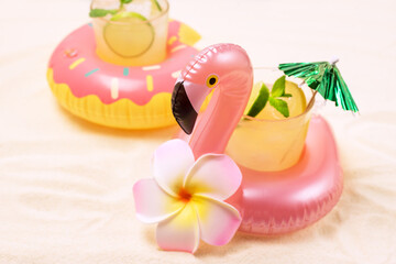Inflatable Donut and Flamingo Toy Ring Holders for Swimming Pool Party with Glass of Cold Cocktail Tropical Monstera Horizontal Horizontal