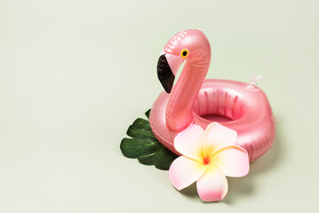 Summer Beach Composition Inflatable Mini Flamingo on Pastel Green Background Pool Float Party Trendy Summer concept Tropical