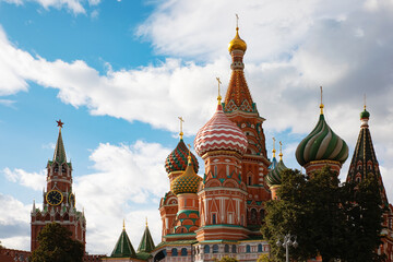 Fototapeta na wymiar St. Basil's Cathedral on red square and the kremlin clock in Moscow, Russia