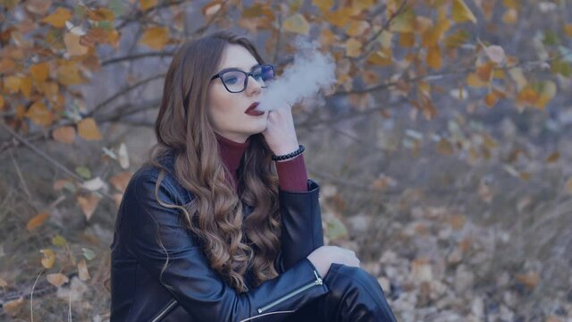 beautiful girl smokes an electronic cigarette. close-up