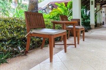 Empty brown wooden table and chair set for sitting and resting in the corridor area of the building