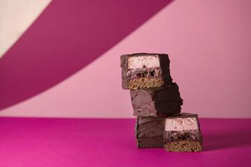 chocolate brownies with lingonberry cream, a layer of mousse and nut praline. on a bright background. advertising of premium confectionery products, a blog with recipes. advertising of consumer loans.