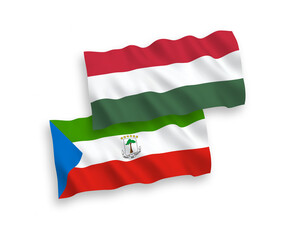 National vector fabric wave flags of Republic of Equatorial Guinea and Hungary isolated on white background. 1 to 2 proportion.