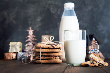 Milk for Santa Claus and Christmas cookies on dark background close-up and copy space concept...
