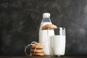 Milk for Santa Claus and Christmas cookies on dark background close-up and copy space concept...