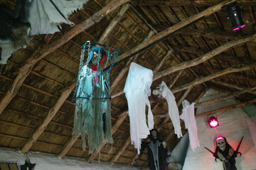 halloween decorations with flying ghosts and death knights under a wooden roof - 466137784