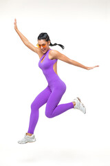 Fototapeta na wymiar Cheerful sportswoman jumping and smiling