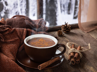 Cup of hot chocolate with winter background