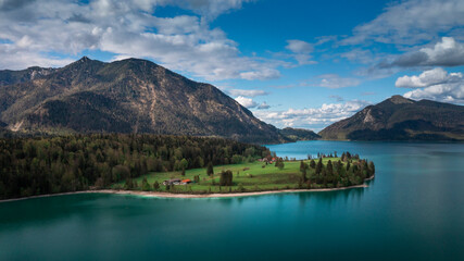 Obraz premium Lake Walchensee in Bavarian Alps from above with white clouds in blue sky, Bavaria 