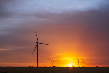 Wind turbines at dawn. Picturesque view of the wind power generator. Production of environmentally friendly energy.