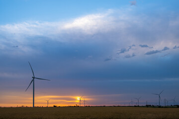 Obraz premium Wind turbines at dawn. Picturesque view of the wind power generator. Production of environmentally friendly energy.