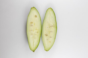 Sliced pointed gourds or potol or parwal green vegetable isolated on white background