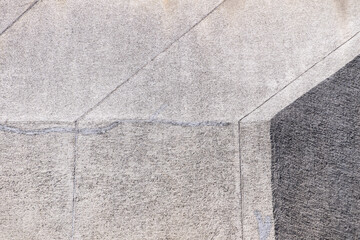 Abstract architectural detail photo of a concrete office building's wall section lit by sun light