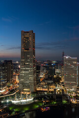 Vertical image of Yokohama Minato Mirai 21 seaside urban area in central Yokohama with Landmark tower at Magic hour