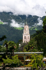 View of Merano in South Tyrol with the parish church of St. Nicholas from the 14th and 15th centuries - Italy.