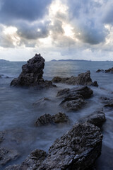 Fototapeta na wymiar long exposure landscape, sea, rocks, clouds, sky, sunset