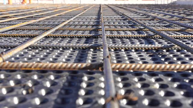 Close up view of reinforcement of concrete. Geometric alignment of Rebars on construction site. Reinforcements steel bars stack.