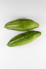 Whole pointed gourds or potol or parwal green vegetable isolated on white background. top view. close up