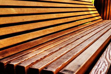 Street bench made of wooden beams. Close-up. Selective focus