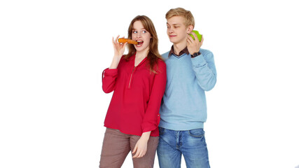 Funny teenagers posing at camera with fruts and vegetables isolated on white backgroud