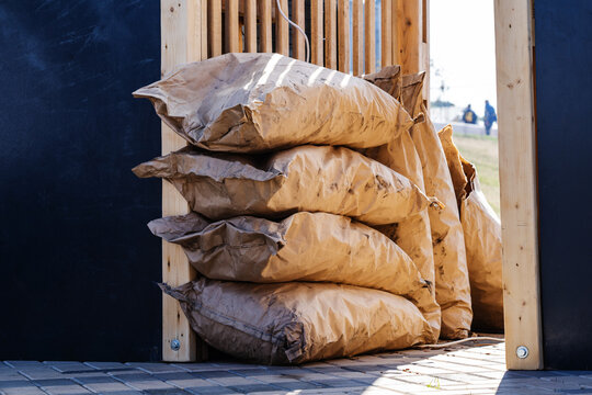 Coal in large paper bags. Procurement of fuel for cooking on fire. Close-up