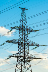 High-voltage power lines. Transmission of electricity by means of poles through agricultural land.