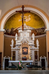 Shkoder, Albania - June 21, 2021: Altar of the St. Stephen's Catholic Church in Shkoder, vertical. Interior of a Christian temple with a cross and sculptures of saints