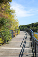 Fototapeta na wymiar Wooden bridge over the river. Autumn in Rochester, New York