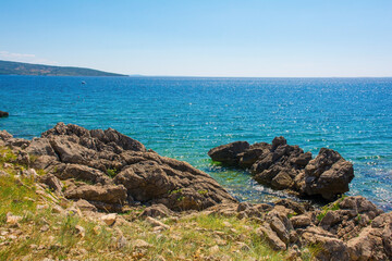 Fototapeta na wymiar The rocky coastline near Krk Town on Krk Island in the Primorje-Gorski Kotar County of western Croatia 