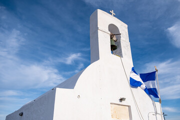 Small chapel, Orthodox Greek church on blue sky background. Serifos island, Greece