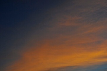 Naklejka na ściany i meble Sunset sky. The cloud is illuminated by the sun.